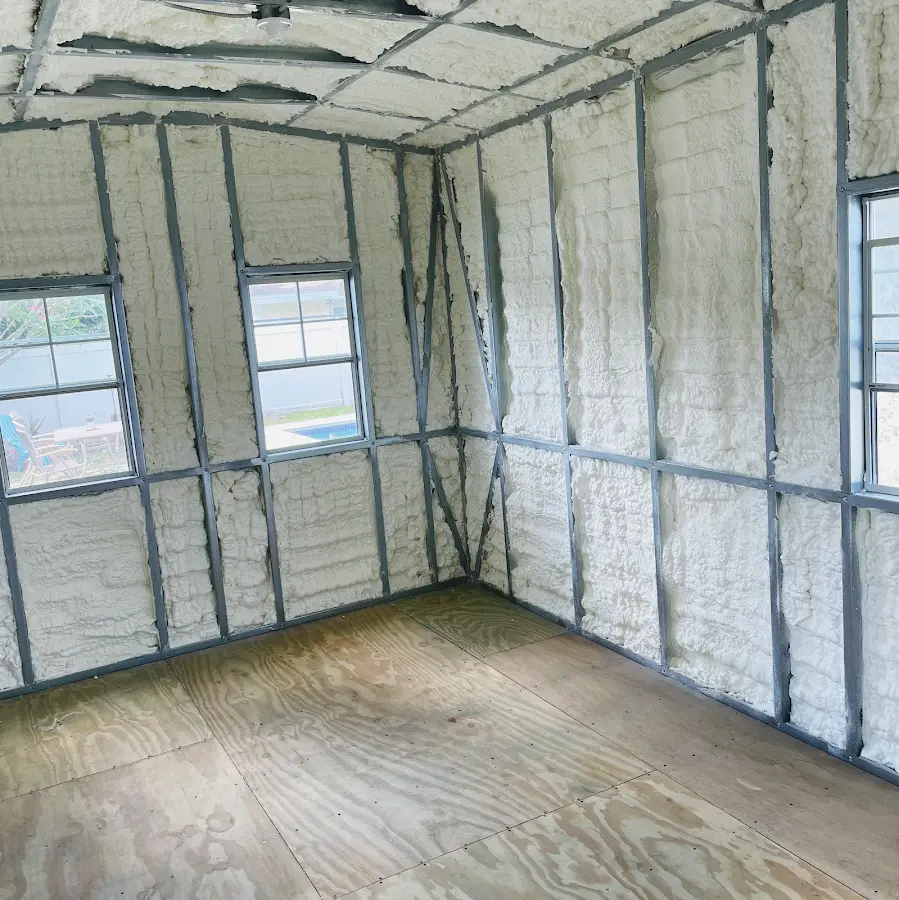 Closed-cell spray foam insulation applied to wall cavities in a residential project in Orchard Park